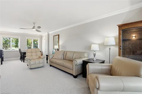 a bedroom with a bed and large windows