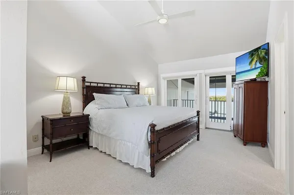 a bedroom with a bed and a mirror