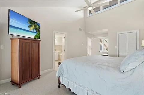 a bathroom with a granite countertop toilet a sink and mirror