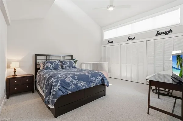 a bedroom with a bed and a couch