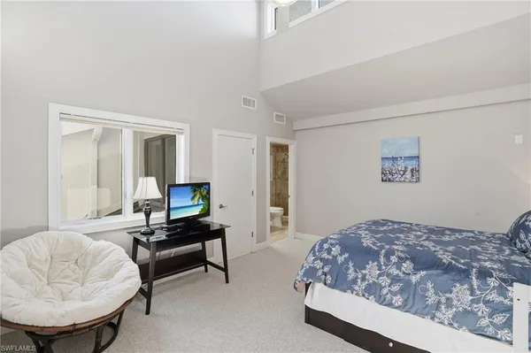 a kitchen with granite countertop a sink and a refrigerator