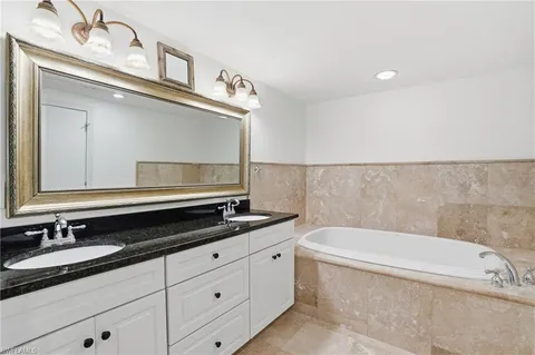 an aerial view of residential houses with outdoor space and swimming pool