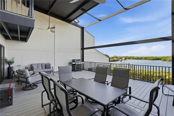 a view of a patio with table and chairs and wooden floor