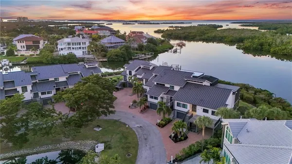 an aerial view of house with yard and ocean view