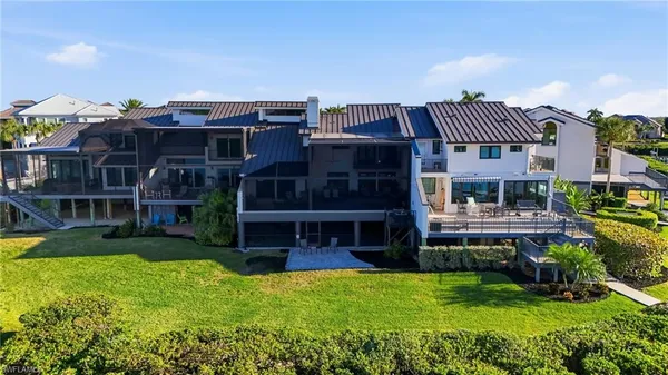 an aerial view of a house with a lake view