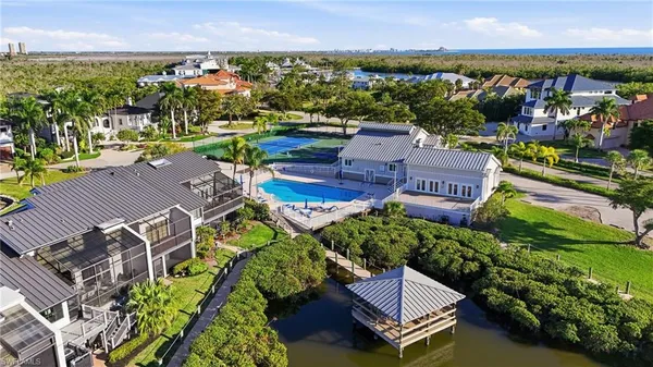 an aerial view of residential houses with outdoor space and swimming pool