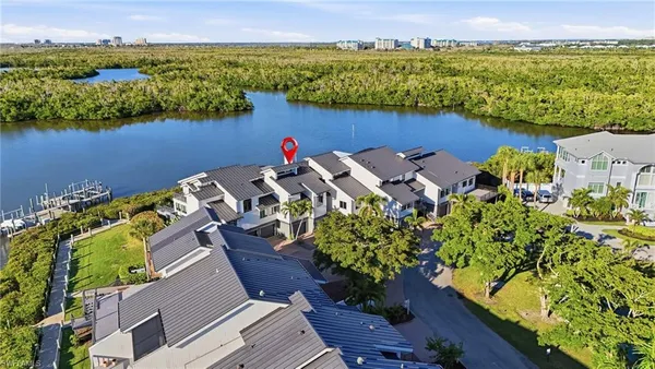 an aerial view of a house with a lake view