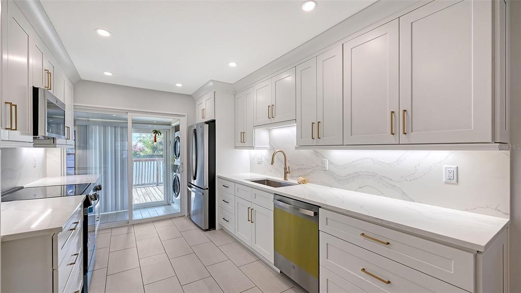 100 Bayshore Road, Unit C Nokomis, FL 34275 - Photo 11 of 39 a kitchen with a sink stainless steel appliances and cabinets