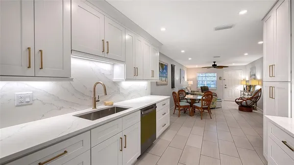 a kitchen with stainless steel appliances granite countertop a sink and cabinets