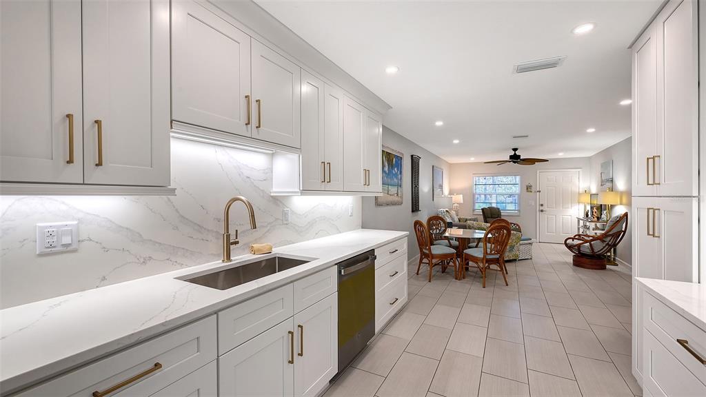 100 Bayshore Road, Unit C Nokomis, FL 34275 - Photo 15 of 39 a kitchen with stainless steel appliances granite countertop a sink and cabinets
