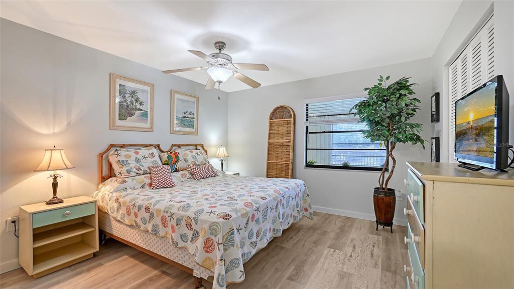 100 Bayshore Road, Unit C Nokomis, FL 34275 - Photo 16 of 39 a bedroom with a bed and a flat screen tv