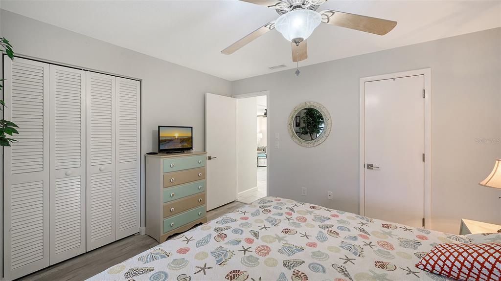 100 Bayshore Road, Unit C Nokomis, FL 34275 - Photo 17 of 39 a bedroom with a bed and a television