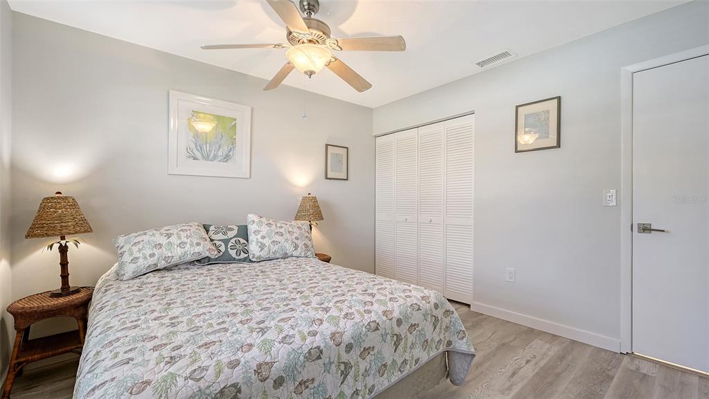 100 Bayshore Road, Unit C Nokomis, FL 34275 - Photo 20 of 39 a bedroom with a bed and a chandelier