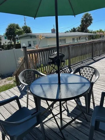 a deck area with furniture and umbrella
