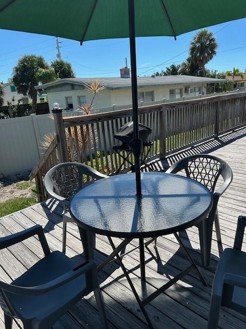100 Bayshore Road, Unit C Nokomis, FL 34275 - Photo 25 of 39 a deck area with furniture and umbrella