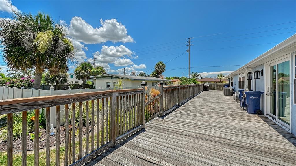 100 Bayshore Road, Unit C Nokomis, FL 34275 - Photo 27 of 39 a view of a balcony with wooden floor and potted plants