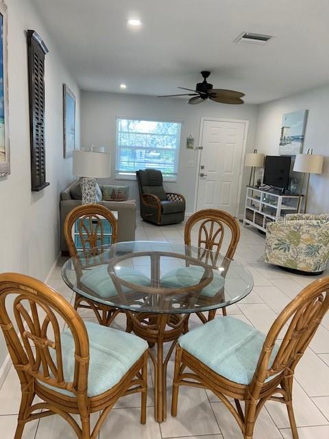 100 Bayshore Road, Unit C Nokomis, FL 34275 - Photo 6 of 39 a dining room with furniture and wooden floor