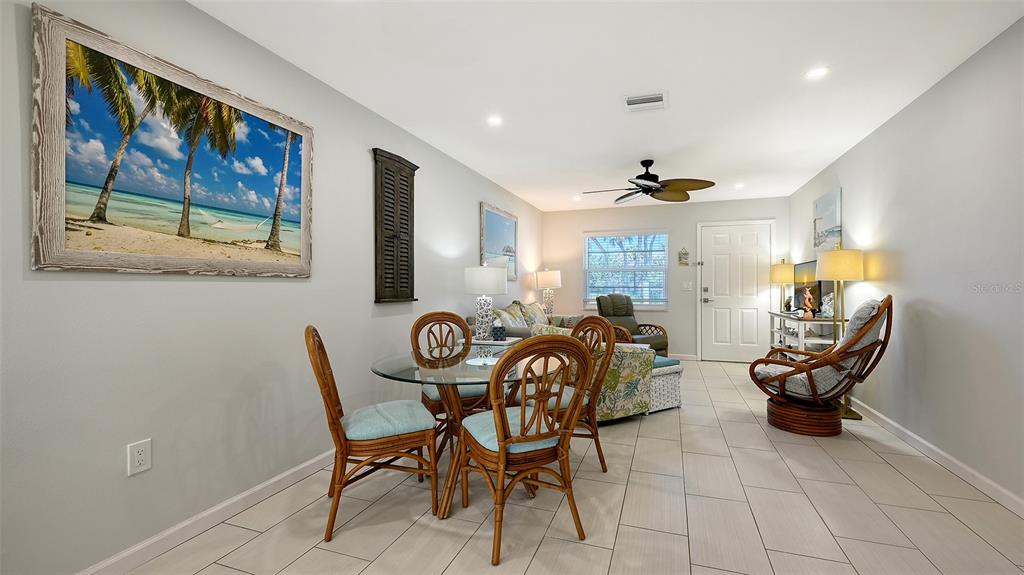 100 Bayshore Road, Unit C Nokomis, FL 34275 - Photo 9 of 39 a view of a dining room with furniture a rug and wooden floor