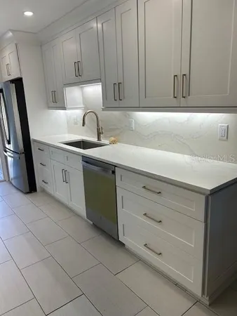 a kitchen with cabinets and appliances