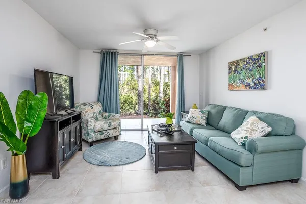 a living room with furniture potted plant and a window