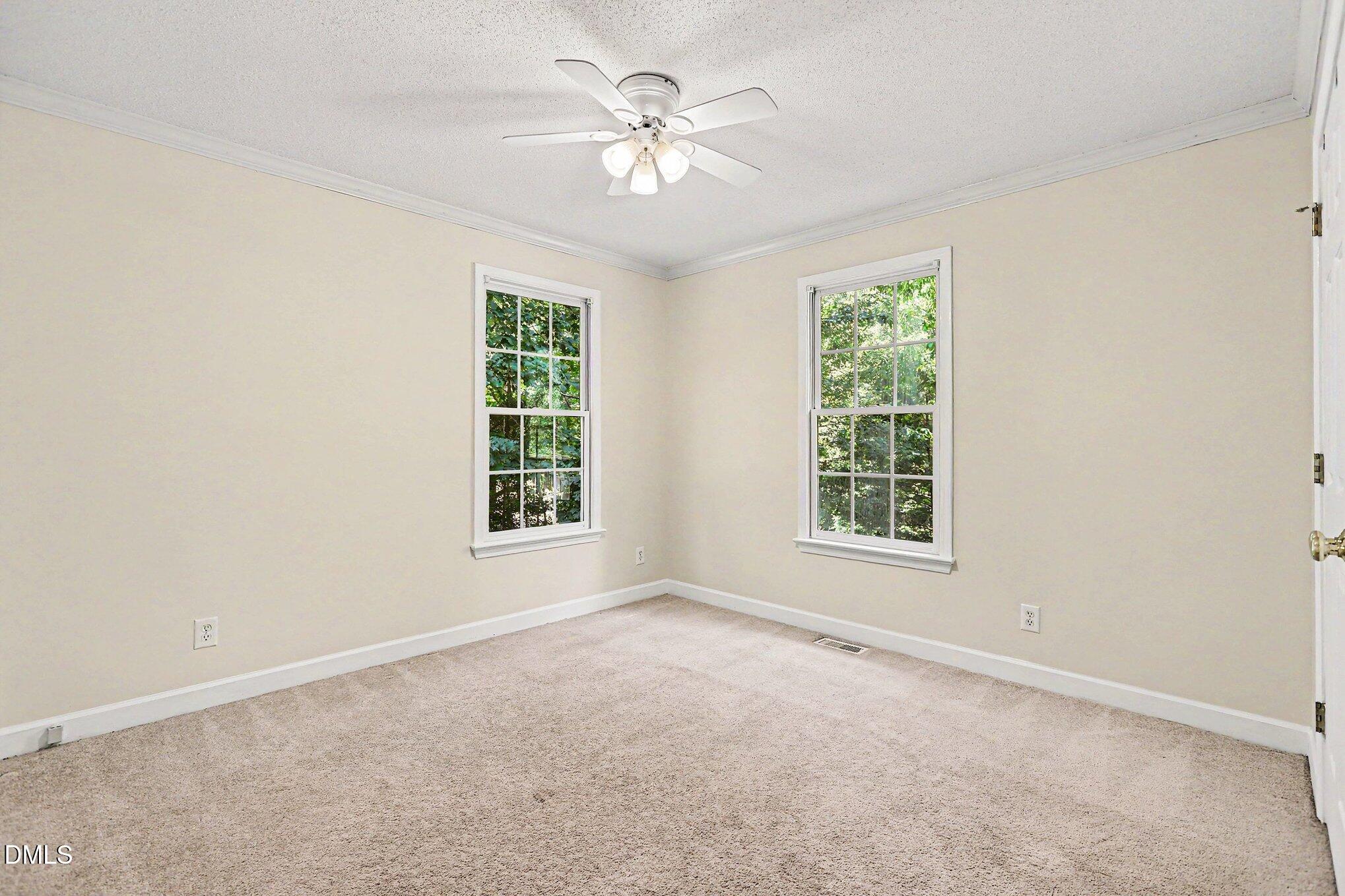 5359 Bass Mountain Road Snow Camp, NC 27349 - Photo 14 of 25 an empty room with windows and chandelier fan