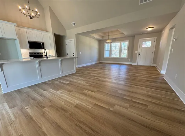 a view of kitchen with sink microwave and refrigerator