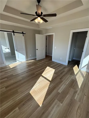 a view of an empty room and wooden floor