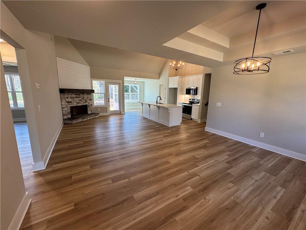 1612 Pickens Street Ball Ground, GA 30107 - Photo 2 of 53 a view of a livingroom with wooden floor and kitchen view