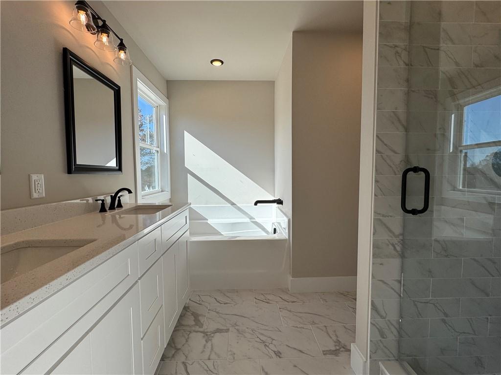 1612 Pickens Street Ball Ground, GA 30107 - Photo 21 of 53 a bathroom with a double vanity sink a mirror and a shower