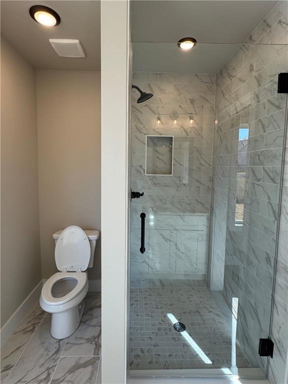 1612 Pickens Street Ball Ground, GA 30107 - Photo 25 of 53 a bathroom with a toilet and a shower