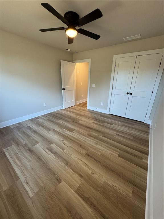 1612 Pickens Street Ball Ground, GA 30107 - Photo 30 of 53 a view of empty room with wooden floor and fan
