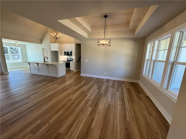 a view of kitchen and hall with wooden floor