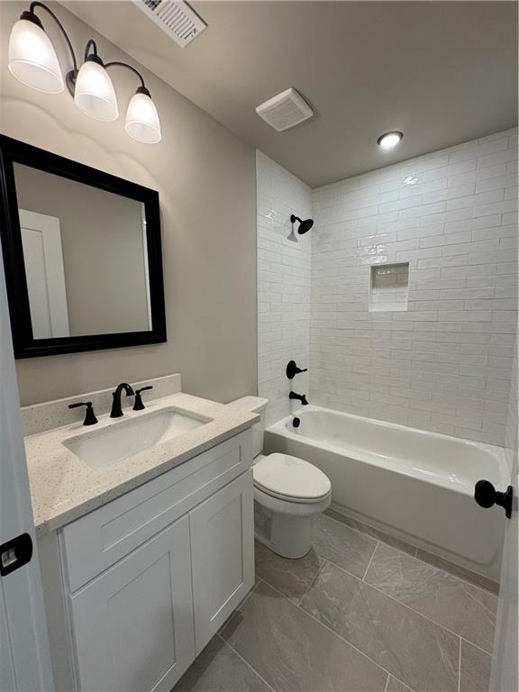 1612 Pickens Street Ball Ground, GA 30107 - Photo 31 of 53 a bathroom with a toilet a sink a mirror and bathtub