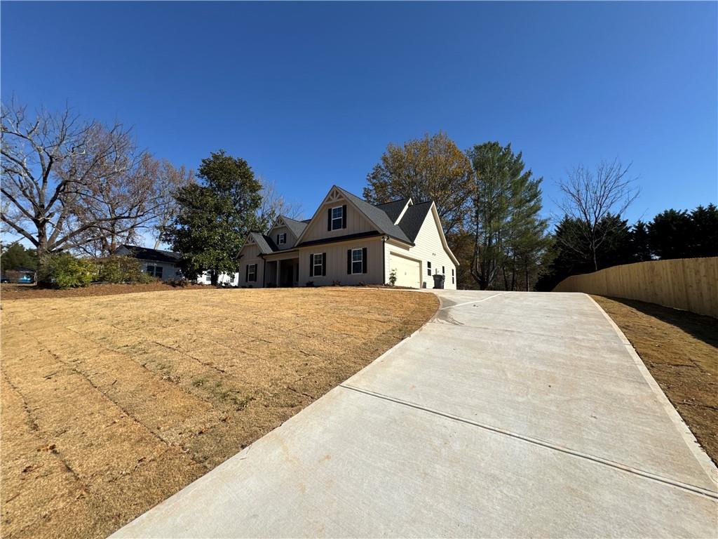 1612 Pickens Street Ball Ground, GA 30107 - Photo 50 of 53 a view of white house with a yard