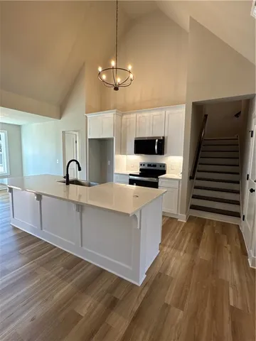 a view of kitchen with sink microwave and stove