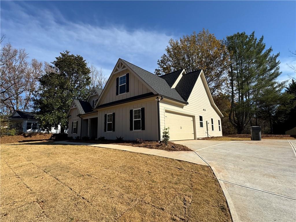 1612 Pickens Street Ball Ground, GA 30107 - Photo 51 of 53 a front view of a house with a yard and garage