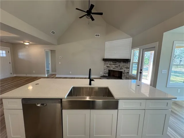 a kitchen with a sink cabinets and window