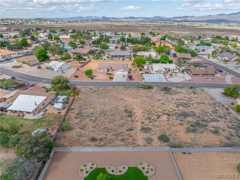 1400 Hidden Canyon Road Kingman, AZ 86401 - Photo 12 of 20 This aerial view showcases a vacant lot with natural desert landscaping, surrounded by established residential properties