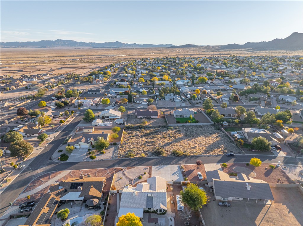 1400 Hidden Canyon Road Kingman, AZ 86401 - Photo 20 of 20 Aerial view showcasing the residential neighborhood with streets and homes, surrounded by expansive desert landscape and distant mountains