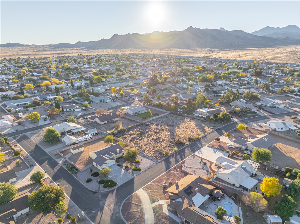 1400 Hidden Canyon Road Kingman, AZ 86401 - Photo 2 of 20 This aerial view showcases the property within a well-established neighborhood, featuring paved streets and surrounding terrain