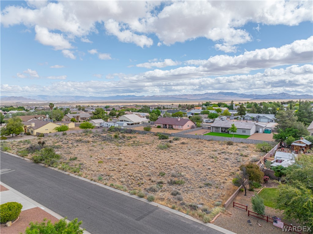 1400 Hidden Canyon Road Kingman, AZ 86401 - Photo 4 of 20 This property features a large, undeveloped lot with a paved road visible in the foreground