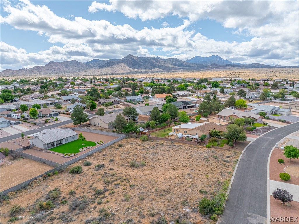 1400 Hidden Canyon Road Kingman, AZ 86401 - Photo 7 of 20 This property features an expansive lot, a well-maintained lawn, and a fenced yard