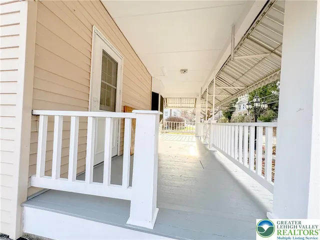 a view of a porch with wooden floor and fence