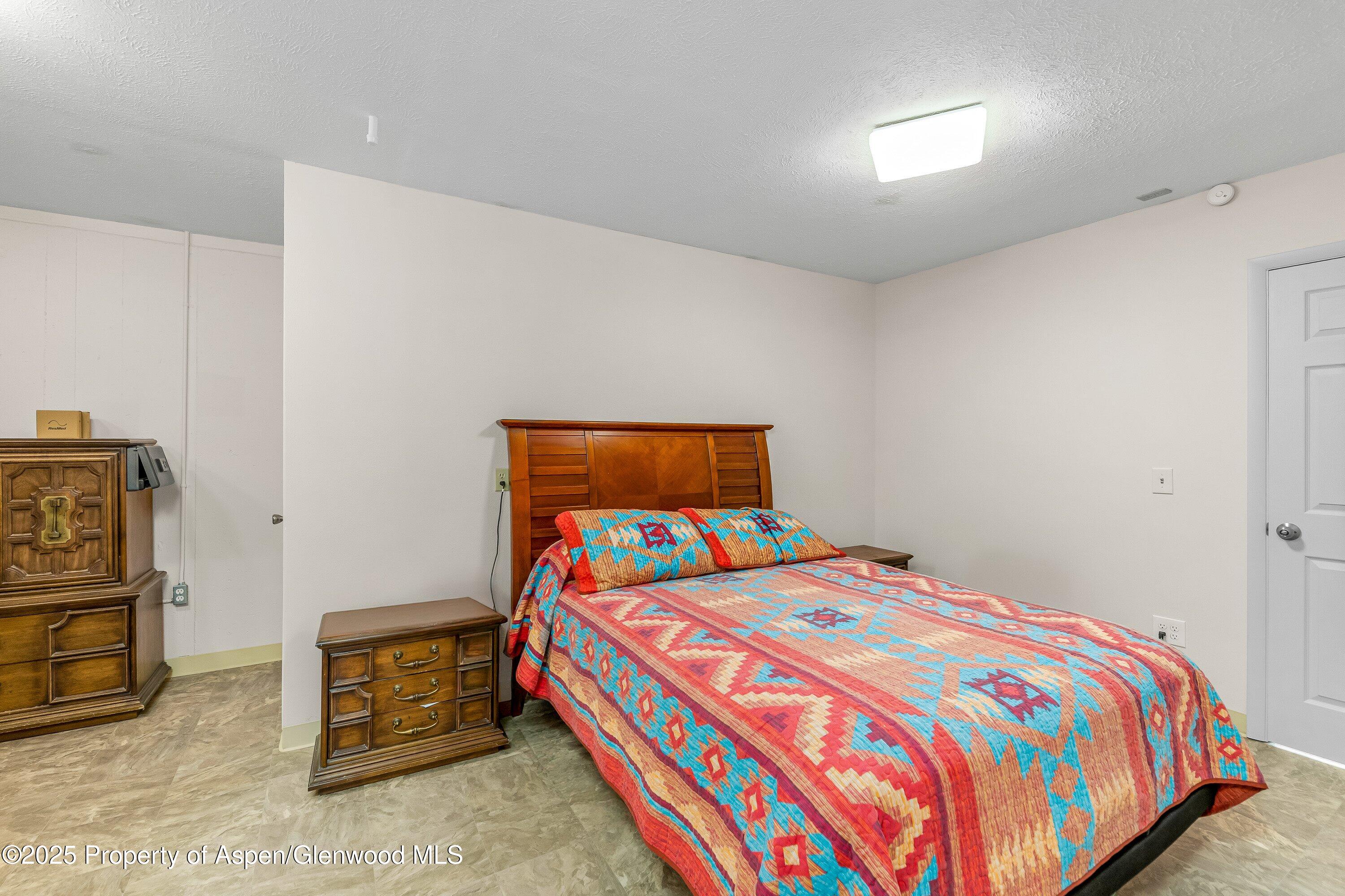 12602 25 Mesa Road Delta, CO 81416 - Photo 5 of 96 a bedroom with a bed and a couch