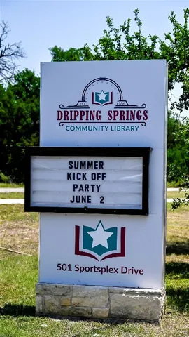 a view of outdoor space with signage and flags