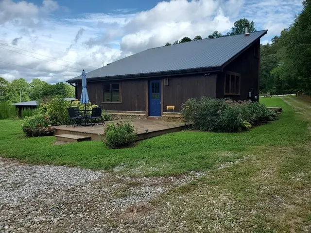 a front view of a house with garden and porch