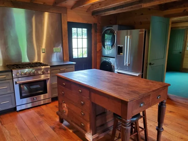 a kitchen with a stove a sink and a refrigerator