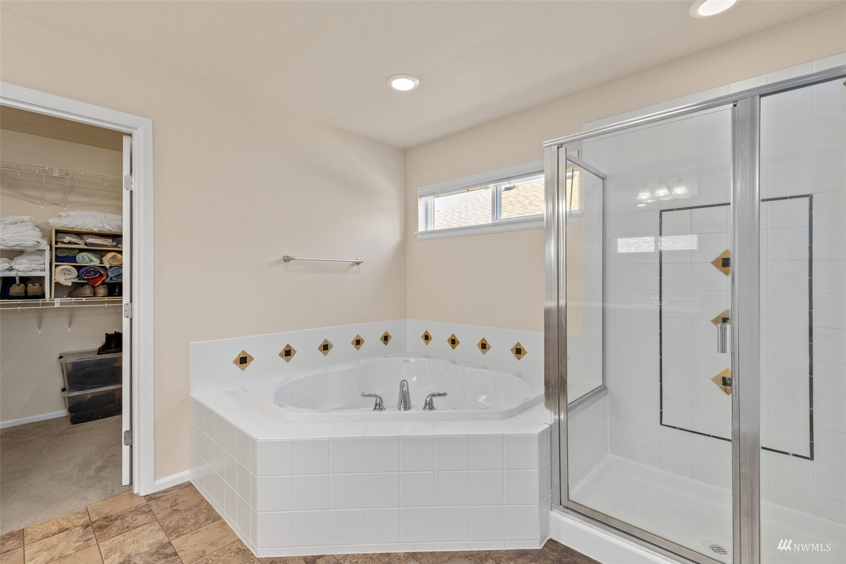 16136 Parkside Way Southeast Renton, WA 98058 - Photo 23 of 40 a white bath tub sitting in a en suite bathroom