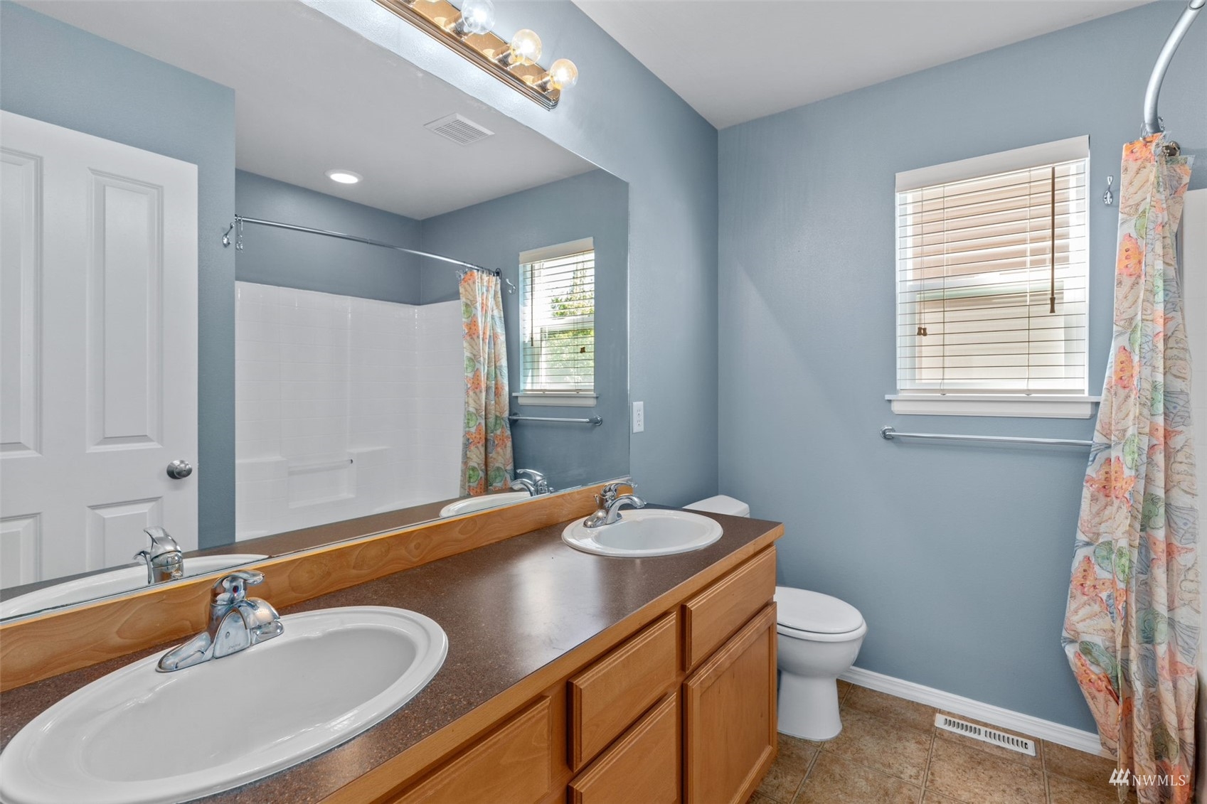 16136 Parkside Way Southeast Renton, WA 98058 - Photo 32 of 40 a bathroom with a sink and a mirror