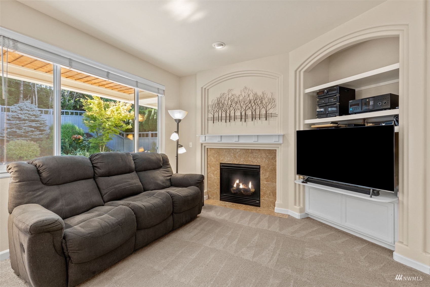 16136 Parkside Way Southeast Renton, WA 98058 - Photo 8 of 40 a living room with furniture a flat screen tv and a fireplace